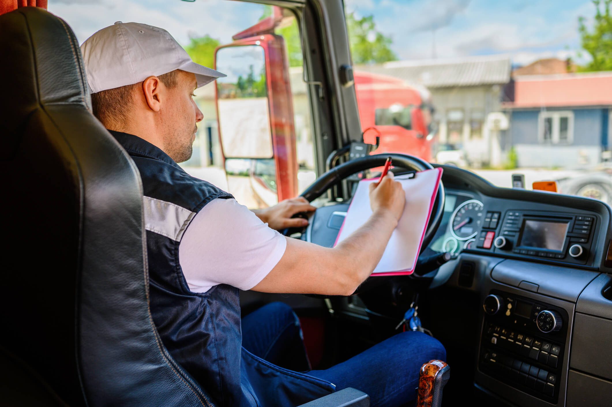 Driver writing in truck cabin