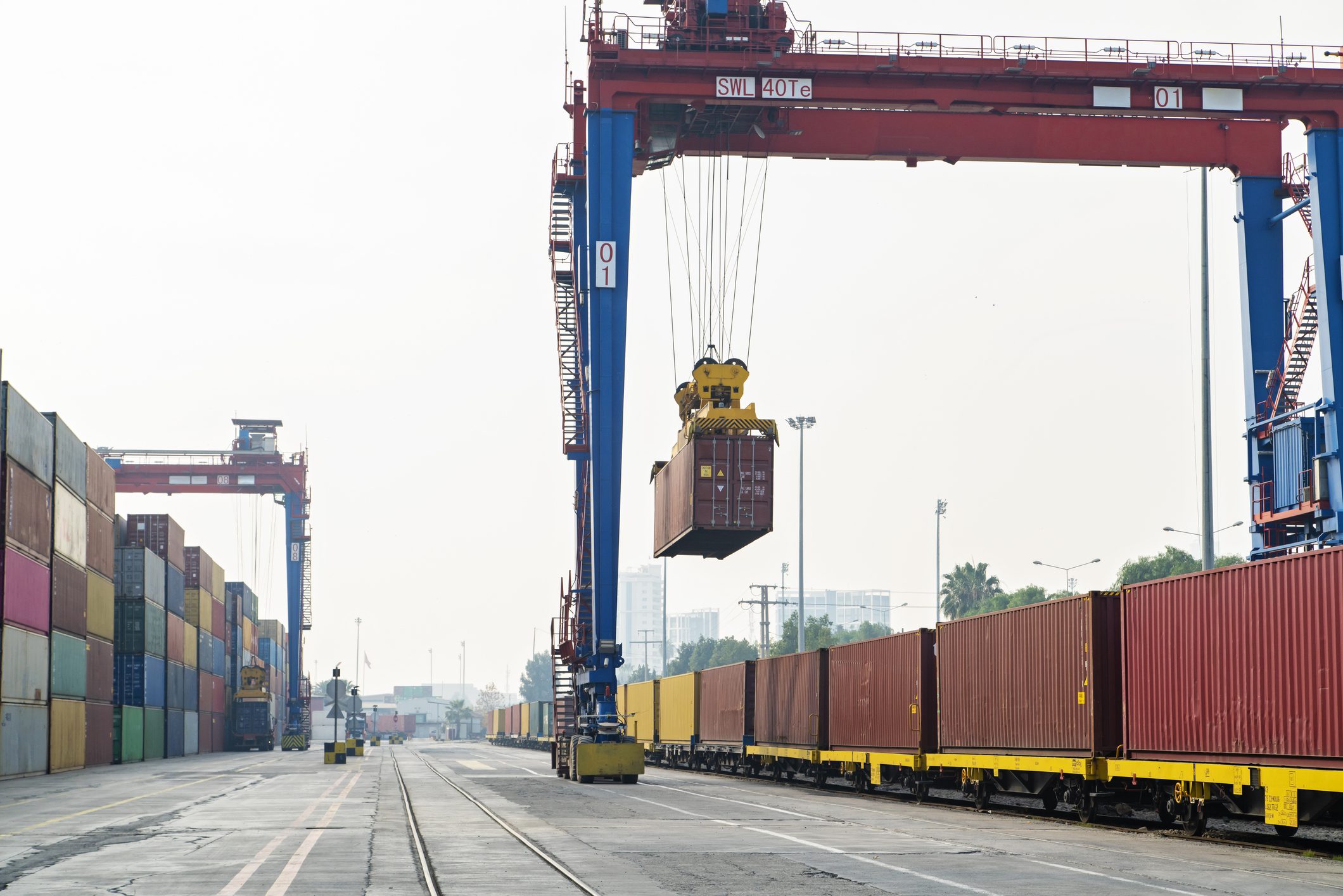 Crane lifting container and loading or unloading the freight train.